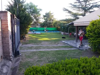 a couple of men playing a game in a yard at Al lado in Cordoba