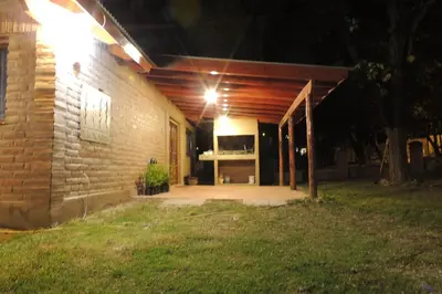 a brick building with a porch at night at Las Acacias in Nono