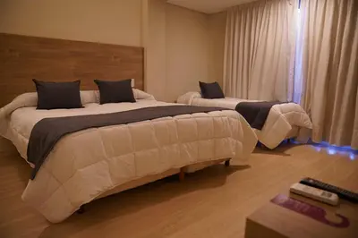 two beds in a hotel room with at Hotel Alpre in Villa Carlos Paz