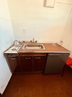 a kitchen with a sink and a stove at Departamentos Centricos Carlos Paz in Villa Carlos Paz