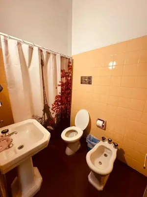 a bathroom with a sink and a toilet and a bidet at Departamentos Centricos Carlos Paz in Villa Carlos Paz