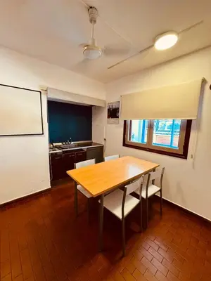 a conference room with a wooden table and chairs at Departamentos Centricos Carlos Paz in Villa Carlos Paz