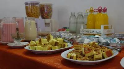 a table topped with plates of food and drinks at Hotel Marqués del Lago in Villa Carlos Paz
