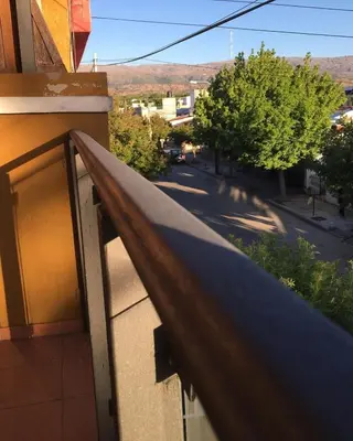 a balcony of a building with a view of a street at Paz y Armonia Habitaciones in Mina Clavero