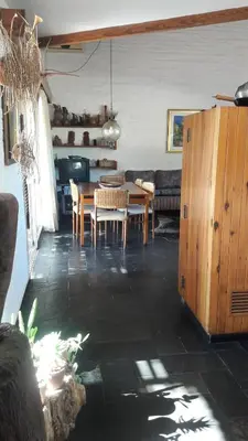 a kitchen and dining room with a table and chairs at Homero y Martín Coronado in Villa Carlos Paz