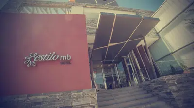 a building with a sign on the side of it at Hotel Estilo MB - Villa Carlos Paz in Villa Carlos Paz