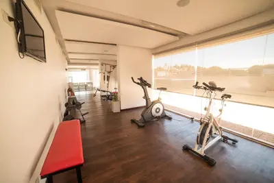 a gym with three exercise bikes in a room at Hotel Estilo MB - Villa Carlos Paz in Villa Carlos Paz