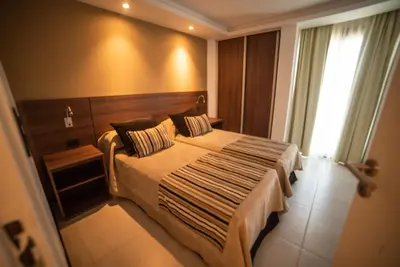 a bedroom with a large bed in a room at Hotel Estilo MB - Villa Carlos Paz in Villa Carlos Paz