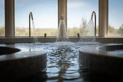 a bathroom with three sinks and water fountain at Portal del Lago Hotel in Villa Carlos Paz