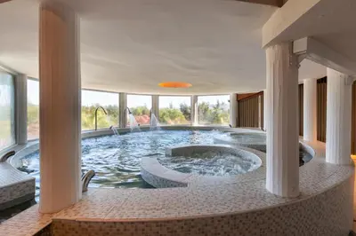 a hot tub in a building with columns at Portal del Lago Hotel in Villa Carlos Paz