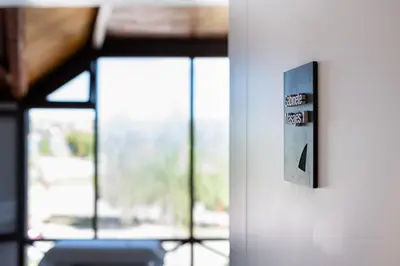 a close up of a lightswitch on a door with windows at Portal del Lago Hotel in Villa Carlos Paz