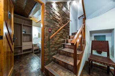 a staircase in a room with a brick wall at Portal del Lago Hotel in Villa Carlos Paz