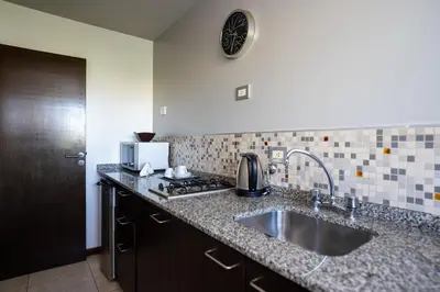 a kitchen with a sink and a counter top at Kube Apartments Express in Cordoba