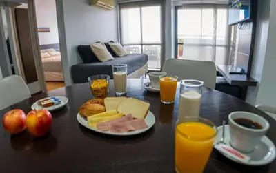 a table with breakfast foods and glasses of orange juice at Kube Apartments Express in Cordoba