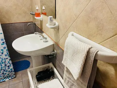a bathroom with a sink and a bath tub at Preludio De Luxe in Villa General Belgrano