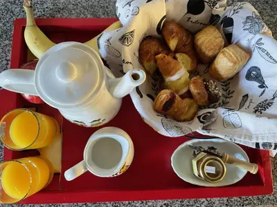 a tray with a cup of coffee and a tray of breakfast foods at Preludio De Luxe in Villa General Belgrano