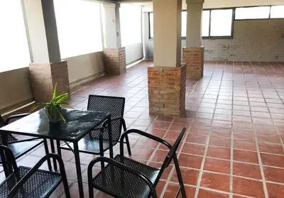 a room with tables and chairs in a building at Hermosa casa con vista al lago in Villa Carlos Paz