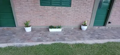 three potted plants sitting in front of a building at Costa Dorada in San Antonio de Arredondo