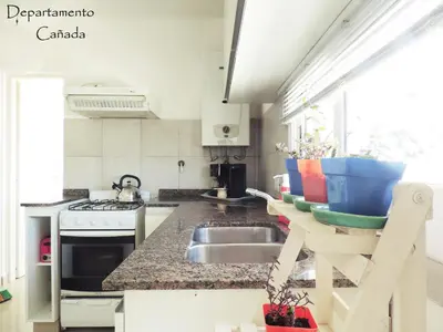 a kitchen with a sink and a counter top at Departamento Cañada Güemes