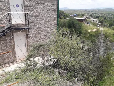 a fence on the side of a building at Departamento Estancia Vieja 74 PB in Estancia Vieja