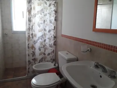 a bathroom with a toilet and a sink at Departamento Estancia Vieja 74 PB in Estancia Vieja