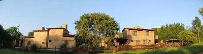 an old house with a fence in front of it at CABAÑAS AGUARI in Santa Rosa de Calamuchita