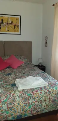 a bed with two white towels sitting on it at Ignacio Garzón Departamento in Cordoba
