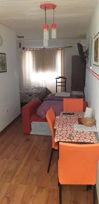 a room with a bed and a table and chairs at Ignacio Garzón Departamento in Cordoba