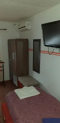 a room with a bed and a flat screen tv at Ignacio Garzón Departamento in Cordoba