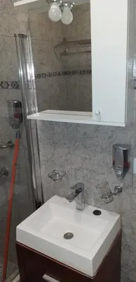 a bathroom with a white sink and a mirror at Ignacio Garzón Departamento in Cordoba