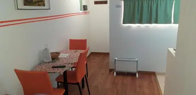 a room with a table and chairs and a window at Ignacio Garzón Departamento in Cordoba