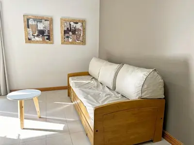 a small room with a bed and a stool at Constantino Iii in Villa Carlos Paz