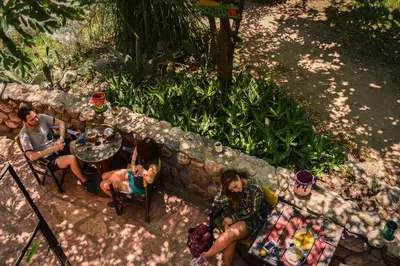 a group of people sitting at a table at Casa Grande Hostel in Merlo