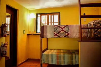 a bedroom with two bunk beds in a room at Casa Grande Hostel in Merlo