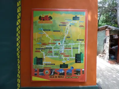 a sign with a map of the amusement park at Casa Grande Hostel in Merlo