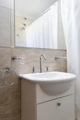 a bathroom with a sink and a mirror at Cabañas Doña Juana in Nono