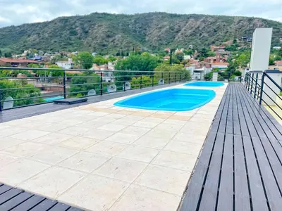 a deck with a swimming pool on top of a house at Vow in Villa Carlos Paz