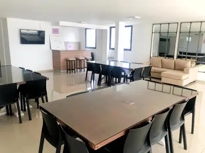 a dining room with tables and chairs and a couch at Vow in Villa Carlos Paz