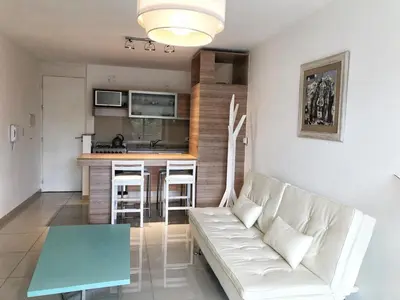 a living room with a couch and a table at Vow in Villa Carlos Paz
