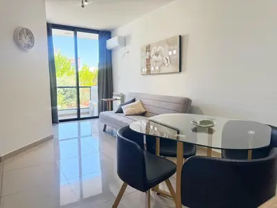 a living room with a glass table and a couch at Vow in Villa Carlos Paz