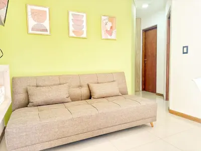 a couch in a room with a green wall at Miralejos Ii in Villa Carlos Paz
