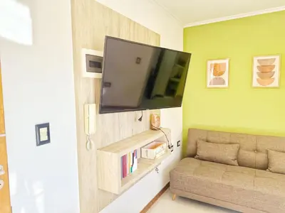 a living room with a couch and a flat screen tv at Miralejos Ii in Villa Carlos Paz