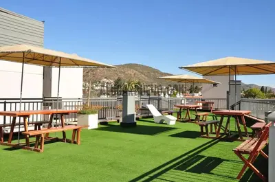 a patio with picnic tables and umbrellas on a roof at Miralejos Ii in Villa Carlos Paz