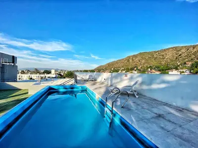 a swimming pool on the roof of a house at Awa in Villa Carlos Paz
