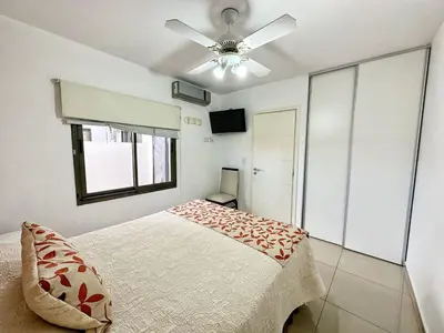 a bedroom with a bed and a ceiling fan at Awa in Villa Carlos Paz