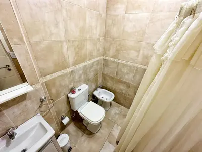 a small bathroom with a toilet and a sink at Awa in Villa Carlos Paz
