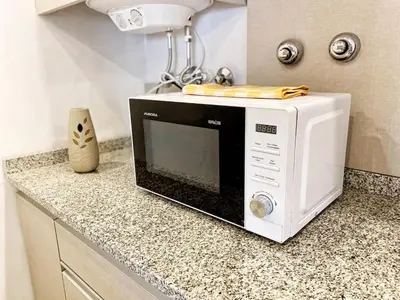 a microwave sitting on a counter in a kitchen at Awa in Villa Carlos Paz