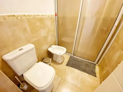 a bathroom with a toilet and a shower at Awa in Villa Carlos Paz