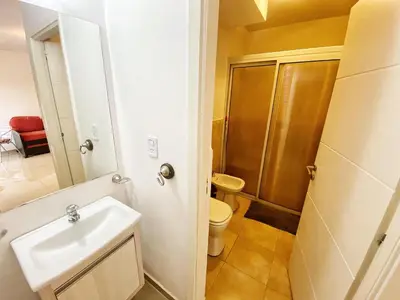 a small bathroom with a sink and a toilet at Awa in Villa Carlos Paz