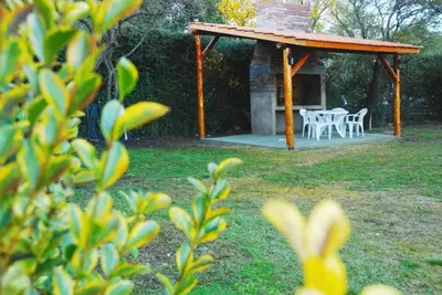 a gazebo with a table and chairs in a yard at El Rincón de Iri-Nan in Merlo